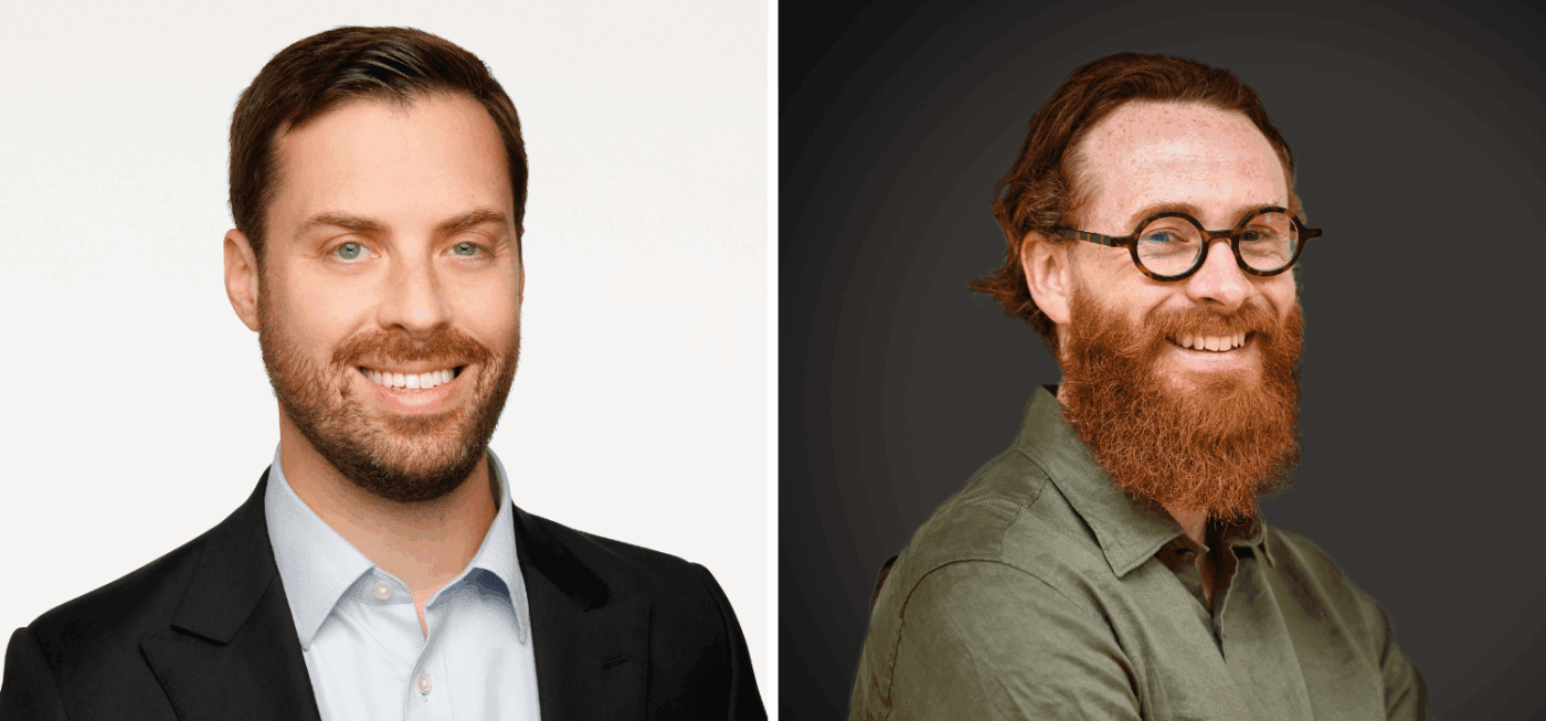 Side-by-side portraits of two men: one with short dark hair and a beard, wearing a suit and light blue shirt; the other with long red hair, a full red beard, round glasses, and a green shirt, smiling against a dark background.