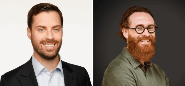 Side-by-side portraits of two men: one with short dark hair and a beard, wearing a suit and light blue shirt; the other with long red hair, a full red beard, round glasses, and a green shirt, smiling against a dark background.